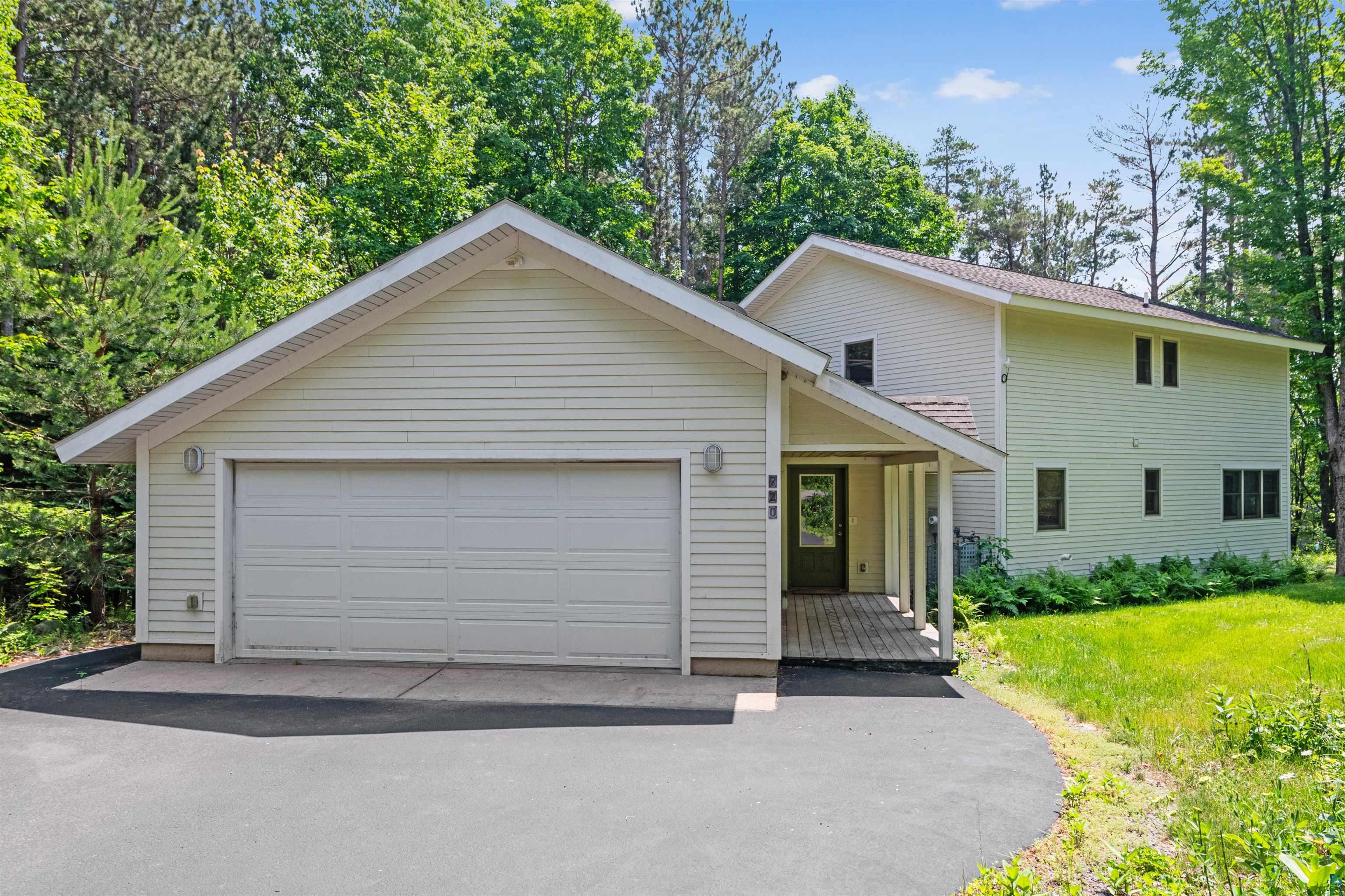 720 Rice Avenue Bayfield, WI 54814 - Photo 2 of 47 View of front of home featuring a garage and a front yard