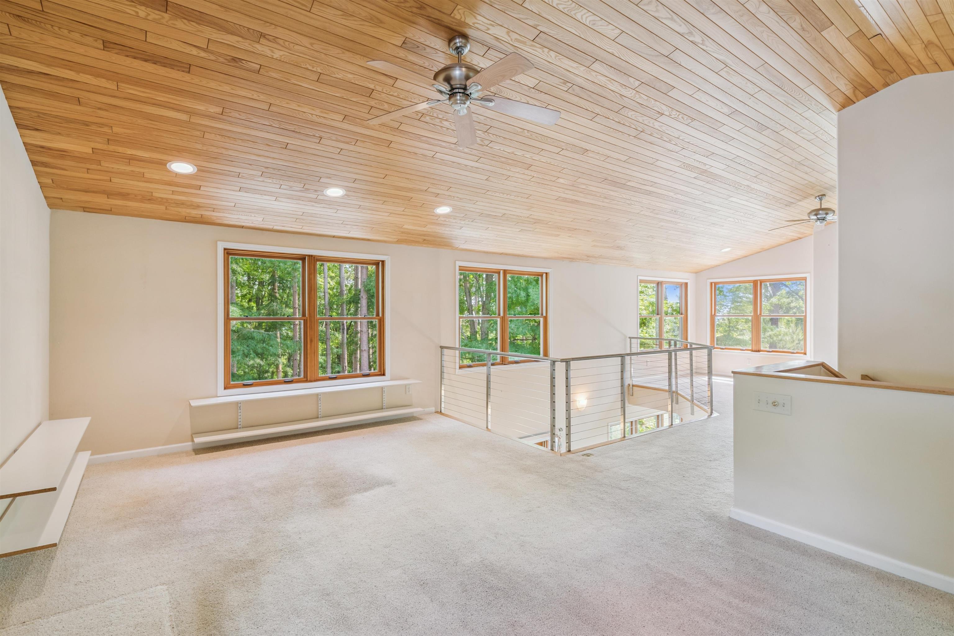 720 Rice Avenue Bayfield, WI 54814 - Photo 23 of 47 Spare room with a ceiling fan, wood ceiling, carpet, plenty of natural light, and lofted ceiling