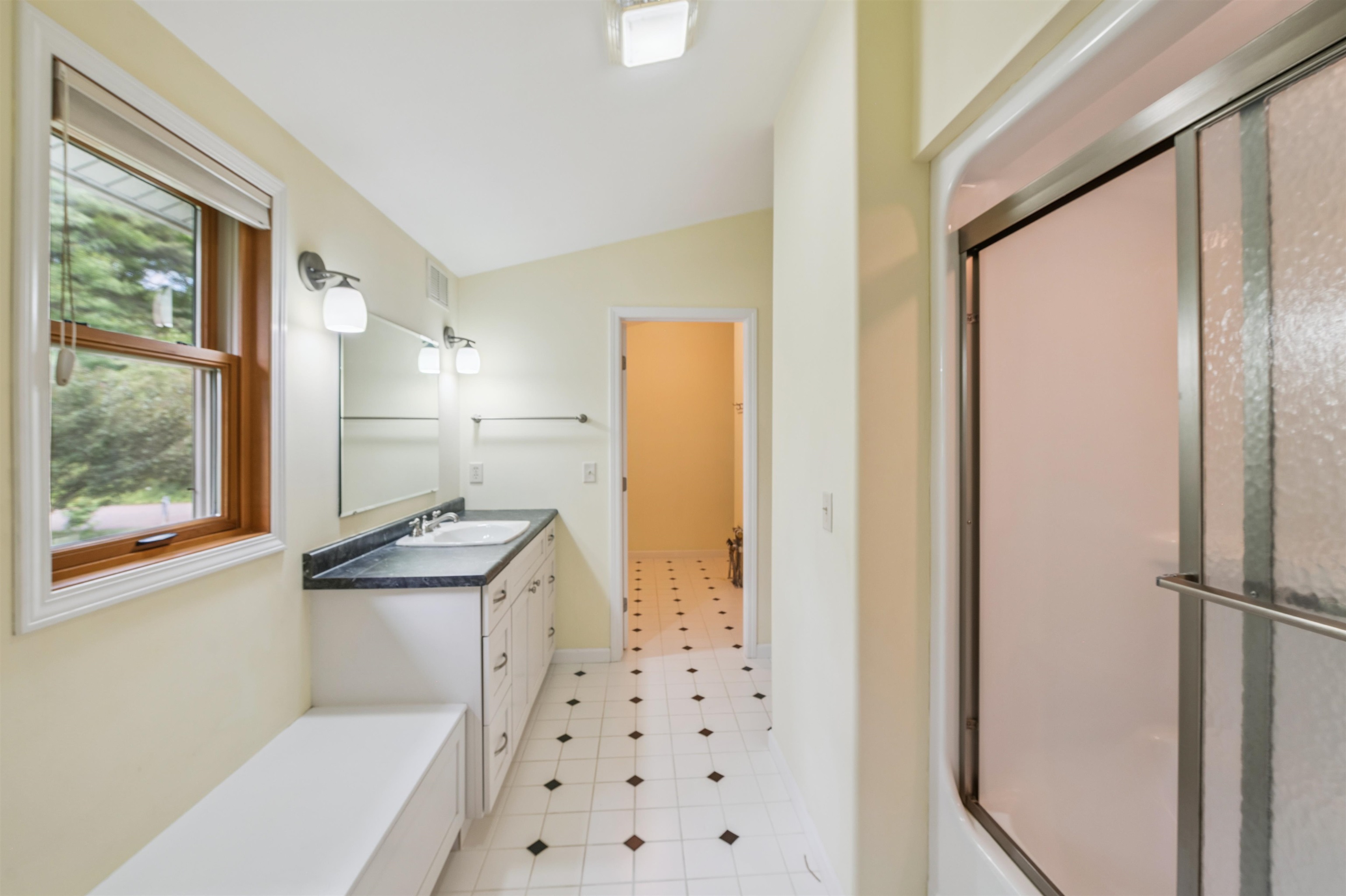 720 Rice Avenue Bayfield, WI 54814 - Photo 25 of 47 Bathroom with an enclosed shower, lofted ceiling, vanity, a tub, and tile patterned floors