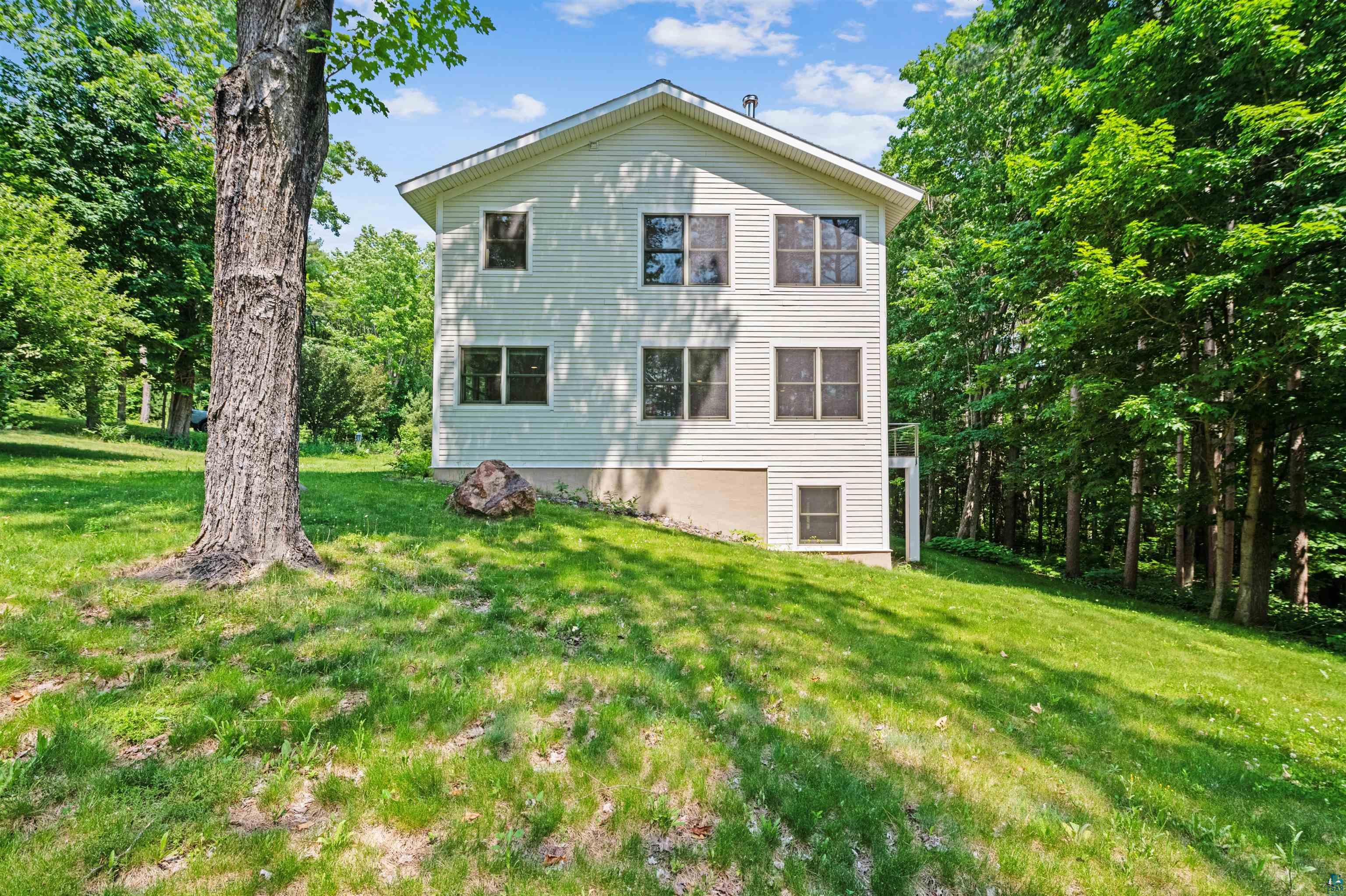720 Rice Avenue Bayfield, WI 54814 - Photo 7 of 47 View of property exterior featuring a yard