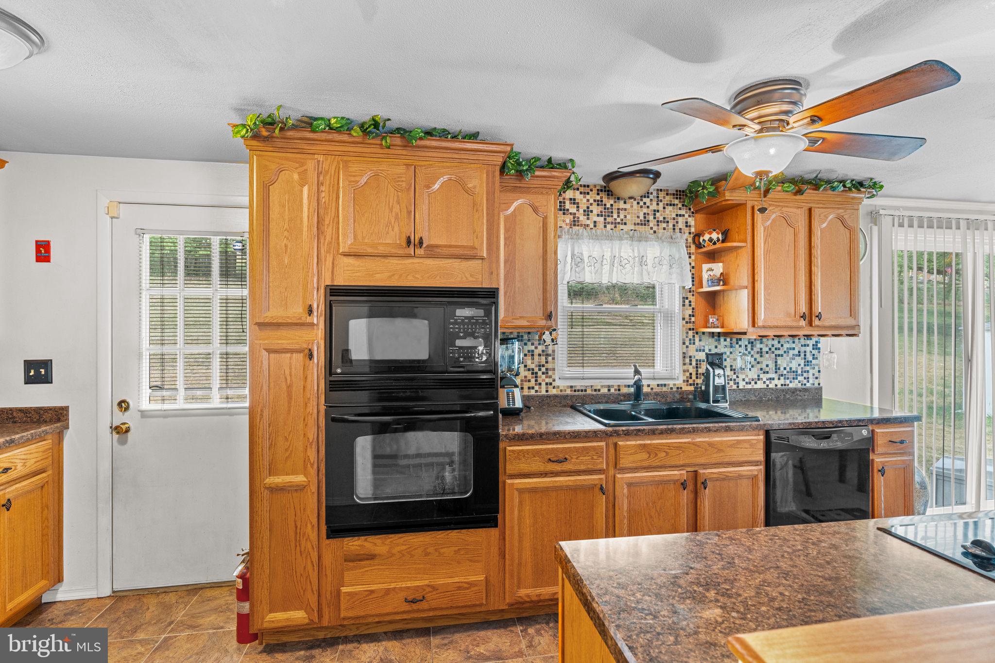 3212 Trinity Road Harrisburg, PA 17109 - Photo 11 of 23 a kitchen with stainless steel appliances granite countertop a stove a sink and a microwave