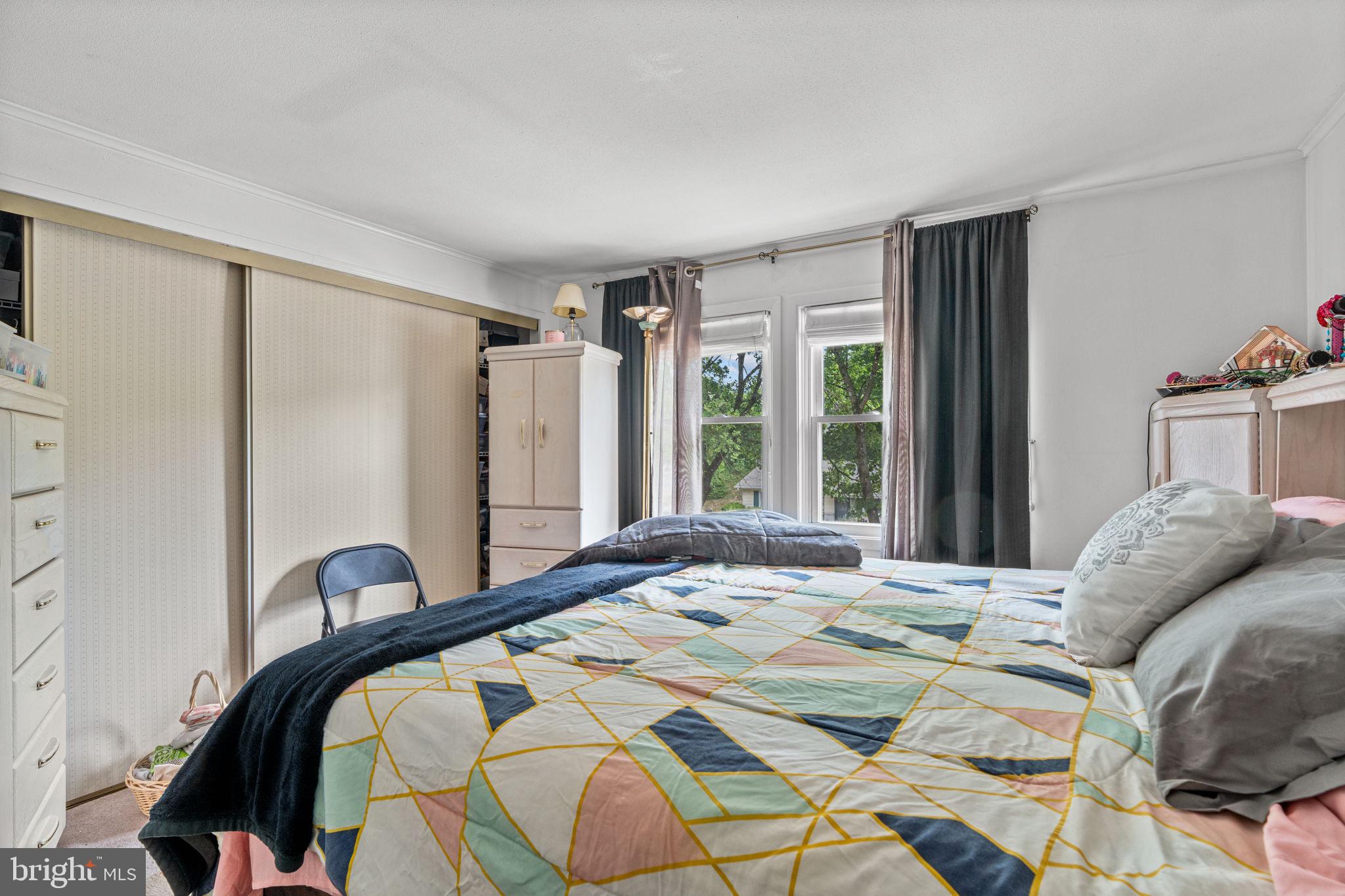 3212 Trinity Road Harrisburg, PA 17109 - Photo 12 of 23 a bedroom with a bed and a large mirror next to a window