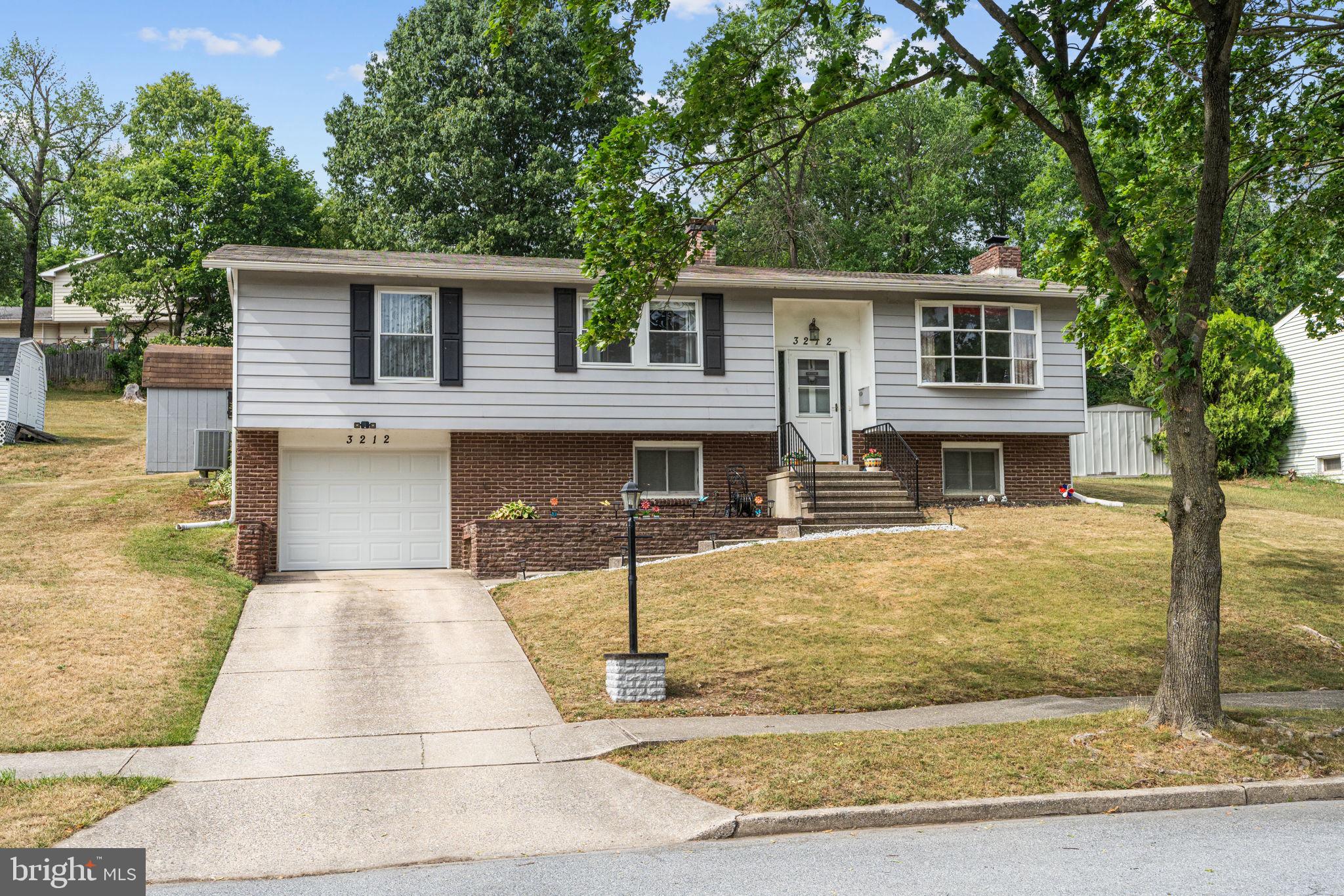 3212 Trinity Road Harrisburg, PA 17109 - Photo 2 of 23 a front view of a house with garden