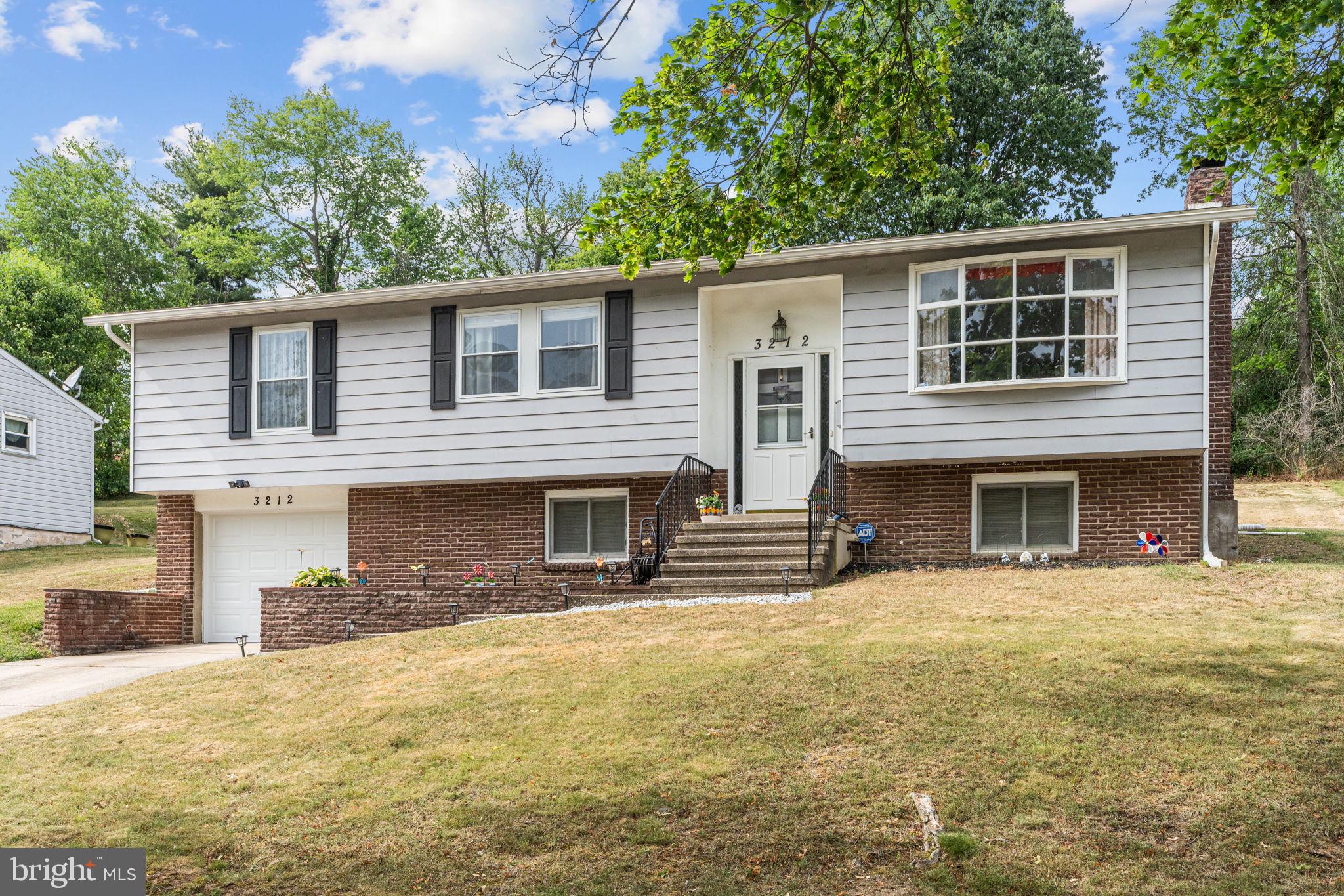 3212 Trinity Road Harrisburg, PA 17109 - Photo 3 of 23 a front view of a house with a yard and garage
