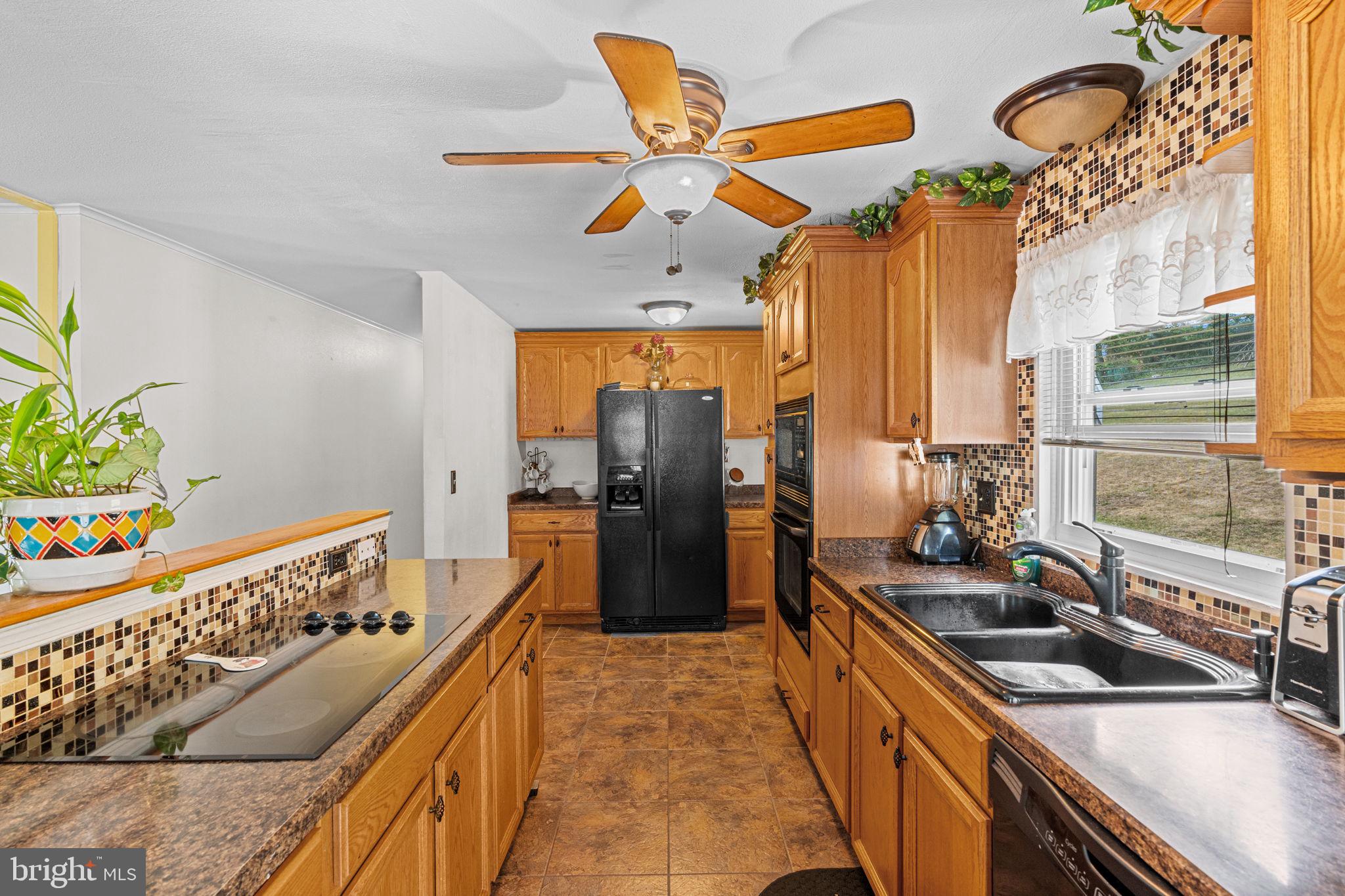 3212 Trinity Road Harrisburg, PA 17109 - Photo 9 of 23 a kitchen with stainless steel appliances a sink stove and a refrigerator