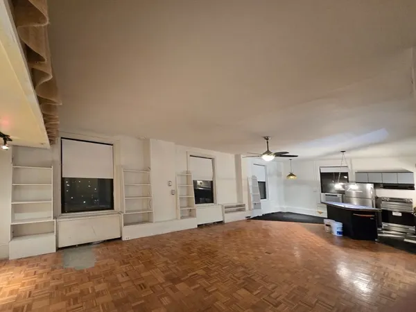 a view of a livingroom with furniture and a flat screen tv