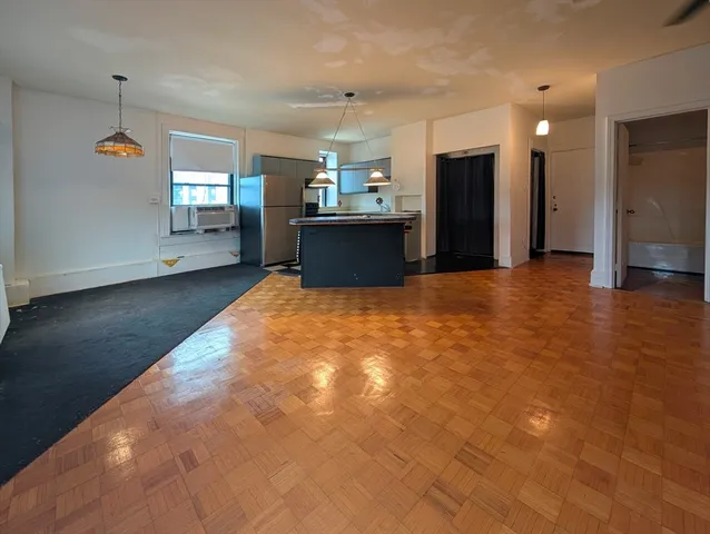 a view of a kitchen with a sink and a refrigerator