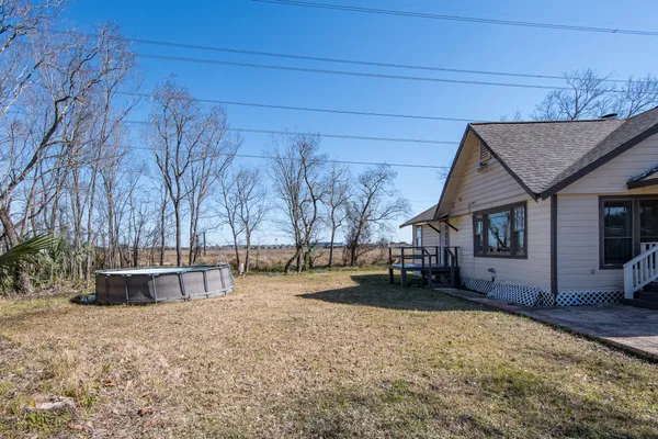 a view of a house with a yard covered in snow