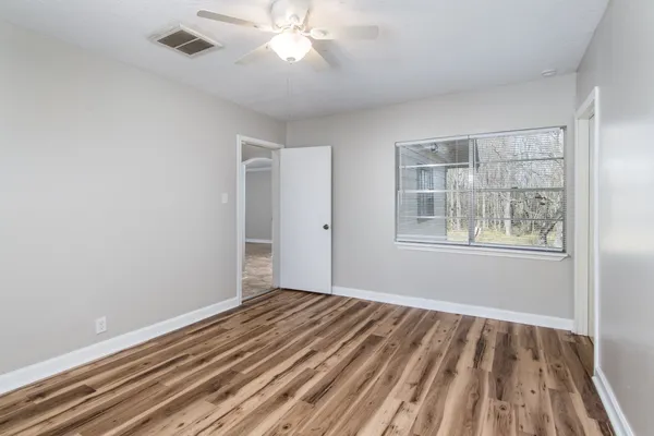 a view of a room with wooden floor and windows
