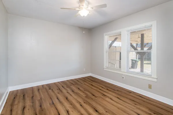 wooden floor in an empty room with a window