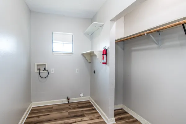 a view of a room with rack on the wall and a window
