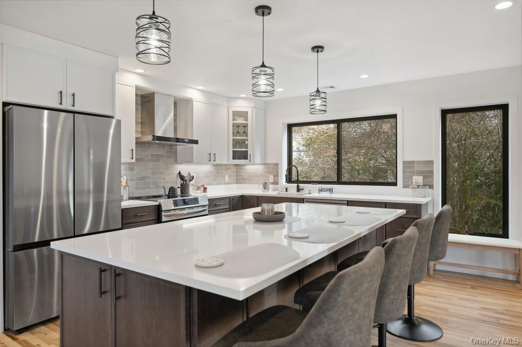 45 Ditch Plains Road Montauk, NY 11954 - Photo 7 of 19 a kitchen with granite countertop a sink a center island stainless steel appliances and cabinets