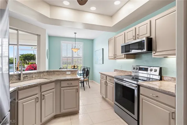 a kitchen with stainless steel appliances granite countertop a sink and stove top oven