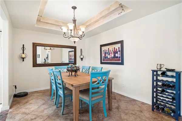 a dining room with furniture a chandelier and window
