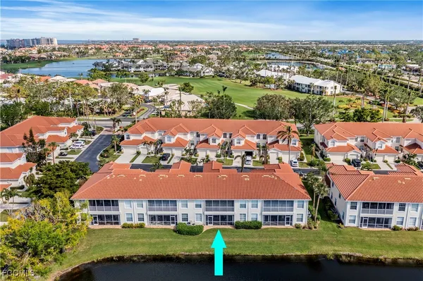 an aerial view of multiple houses with a yard