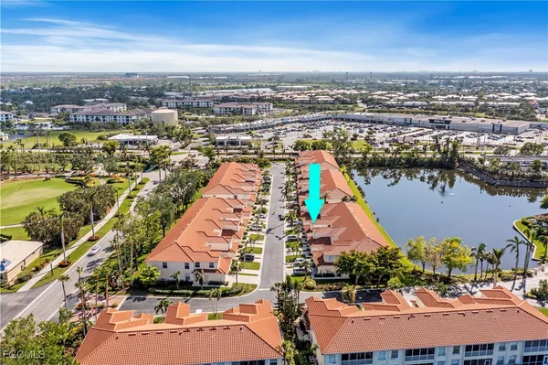 an aerial view of residential building and lake