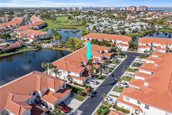an aerial view of a house with a lake