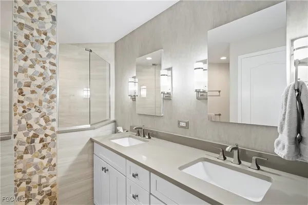 a bathroom with a sink double vanity and a mirror