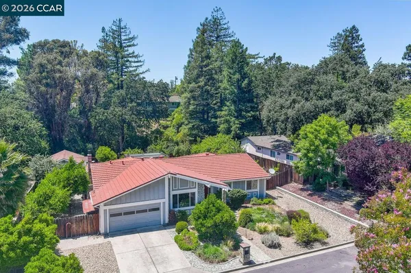 an aerial view of house with yard and outdoor seating