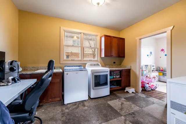 a view of a workspace with furniture and a window