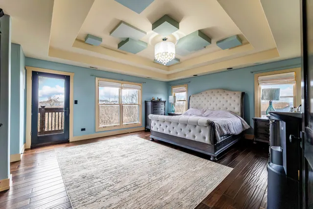 a view of a hallway with wooden floor and closet