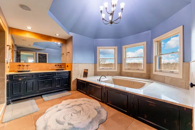 a spacious bathroom with a sink and a large mirror