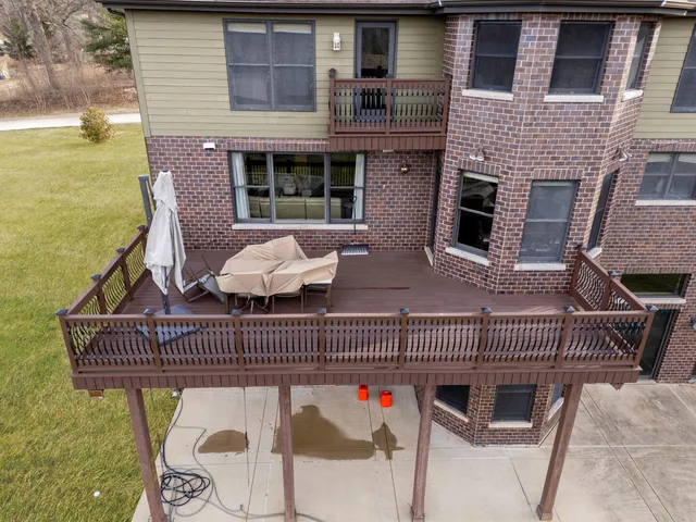 an aerial view of residential house with pool and yard