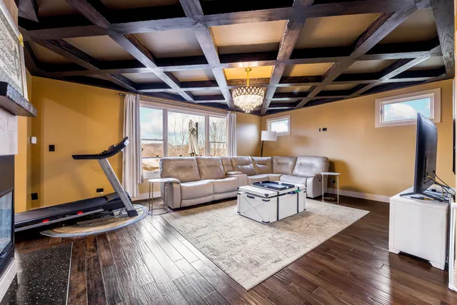 a living room with patio furniture and a wooden floor