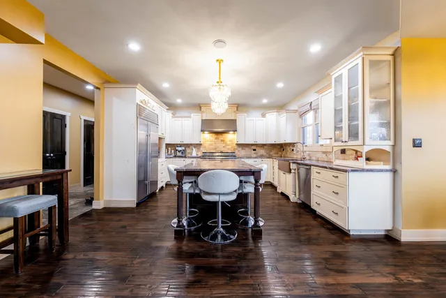 a large kitchen with a table and chairs