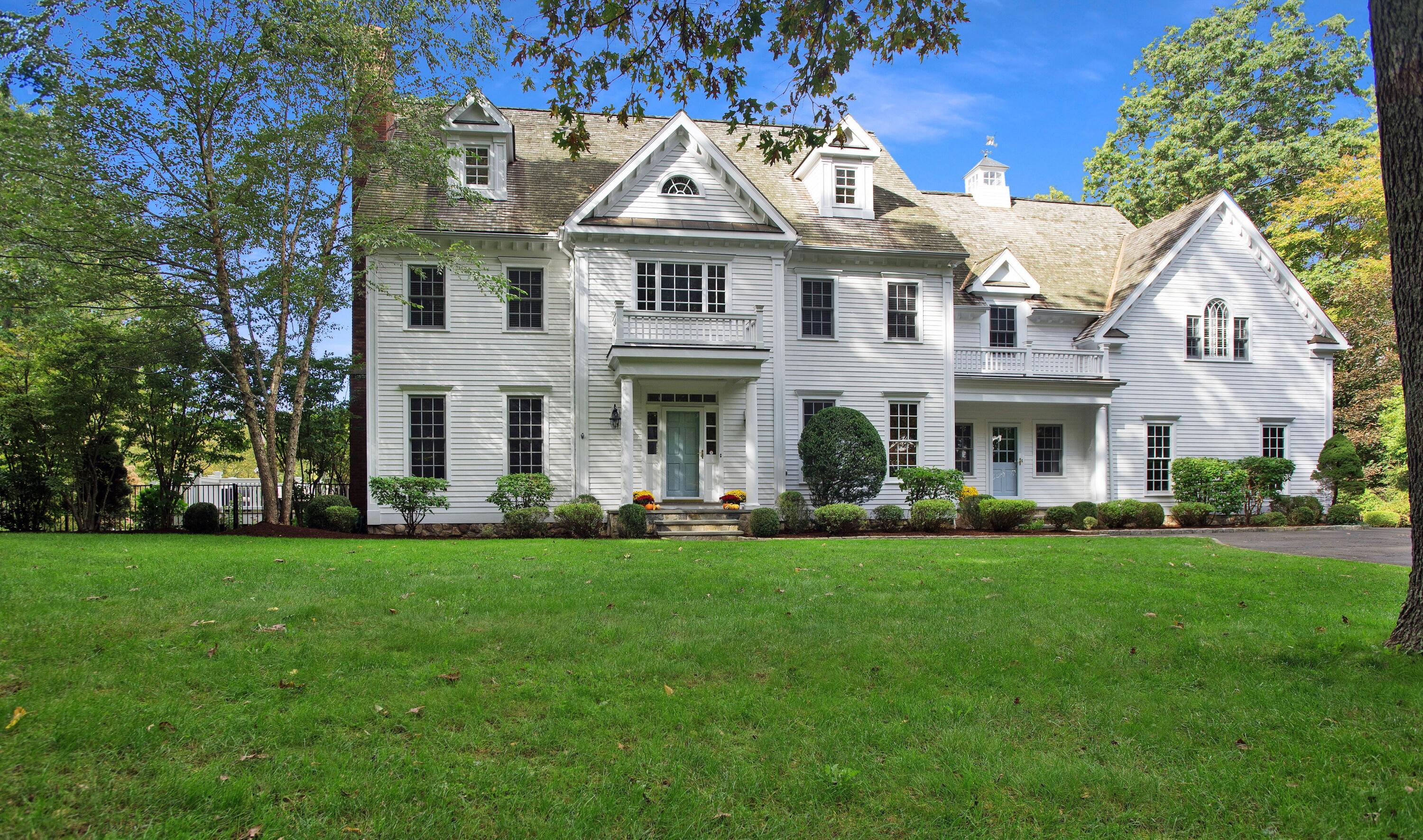 60 Bowery Road New Canaan, CT 06840 - Photo 1 of 49 a front view of a residential houses with yard and green space
