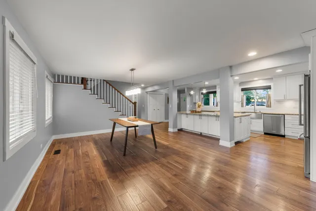 a view of a kitchen with furniture and wooden floor