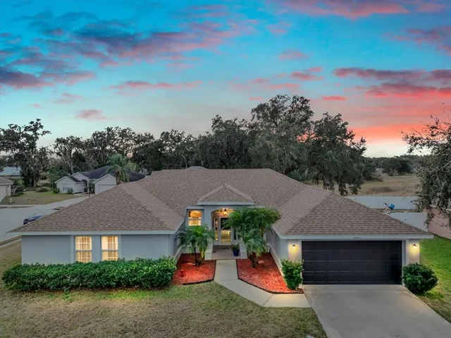 a front view of a house with a potted plant