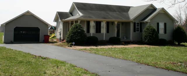 209 Jack Porter Road Lafayette, TN 37083 - Photo 1 of 14 A Wrap arpund porch, detached 1 car garage, storage building, carport, and above ground pool. This home has it all including landscaping.
