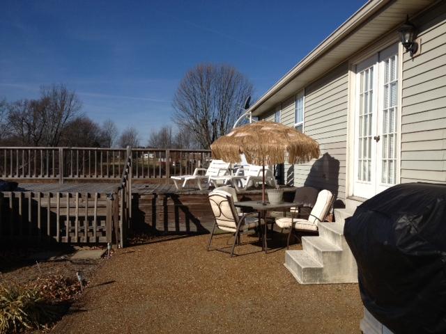 209 Jack Porter Road Lafayette, TN 37083 - Photo 13 of 14 Pebble Stone patio and side deck attached to above ground pool for summer entertaining. Rear french door access to back yard.