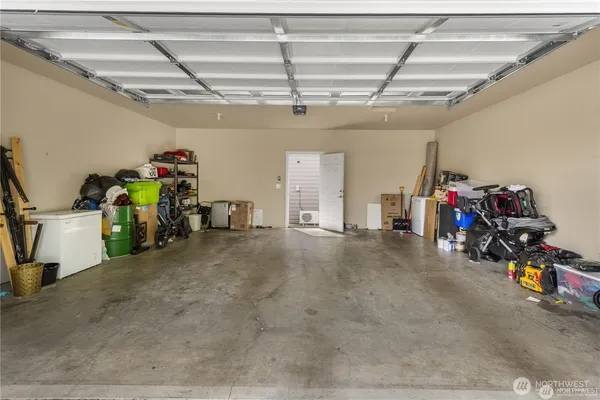 a view of a garage with storage and a white roof