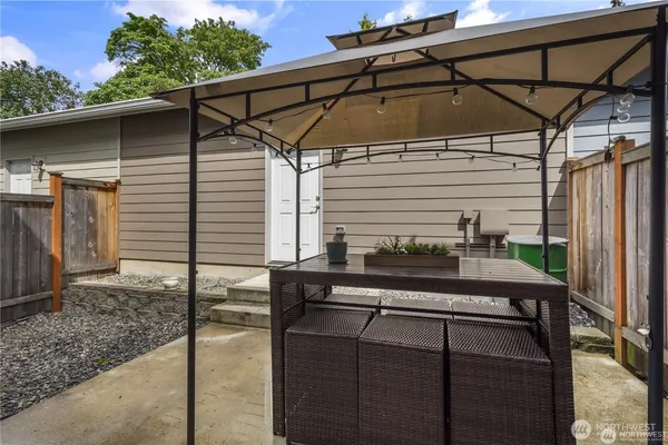 a blue and white and black umbrella in front of a yard