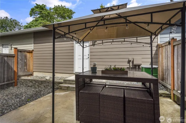 a blue and white and black umbrella in front of a yard