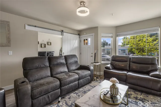 a living room with furniture and a large window
