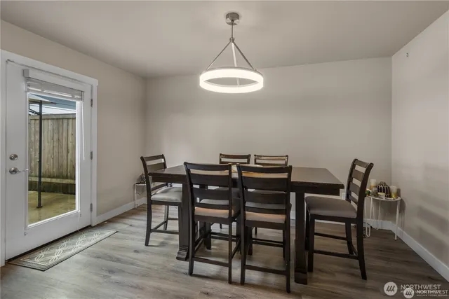 a view of a dining room with furniture and wooden floor