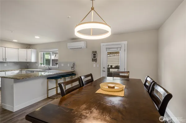 a living room with kitchen and a table