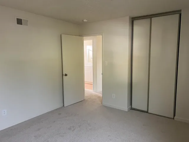 a view of a backyard with wooden fence