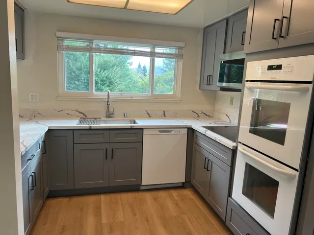 a kitchen with a sink stove and cabinets