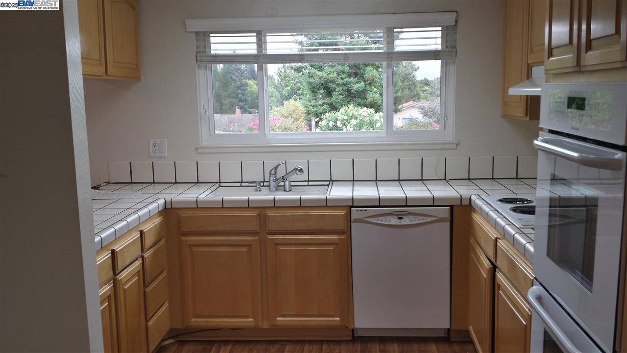 Danville Place Danville, CA 94526 - Photo 7 of 26 a utility room with stainless steel appliances granite countertop a sink stove and window