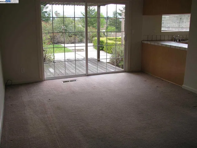 a view of empty room with floor to ceiling windows