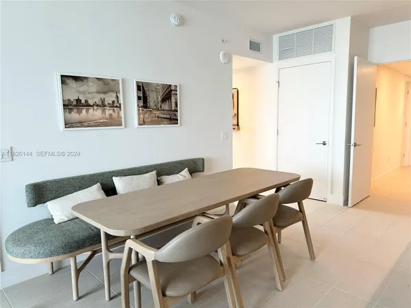 a view of a dining room that has a table and a chair