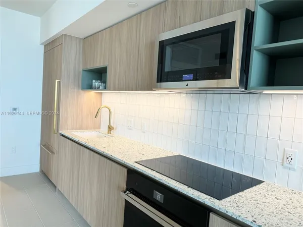 a bathroom with a sink and a microwave