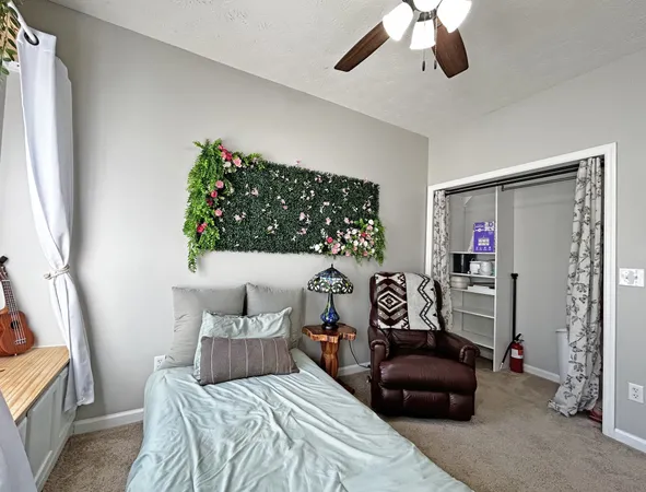 a bedroom with a bed and a chandelier