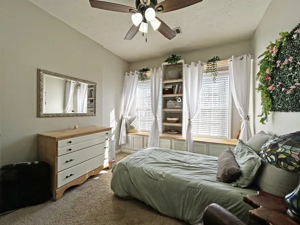 a bedroom with a bed and a window