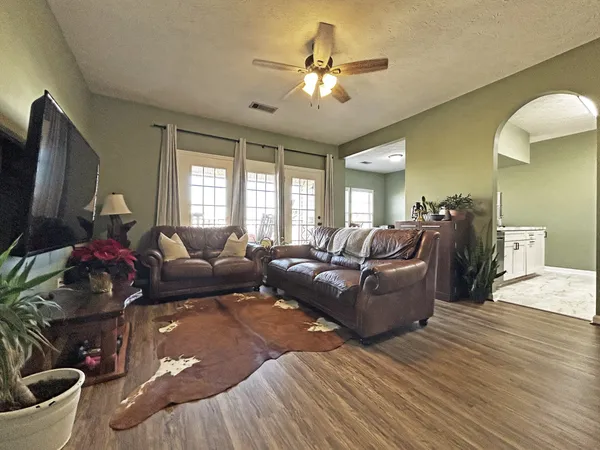 a living room with furniture and a flat screen tv