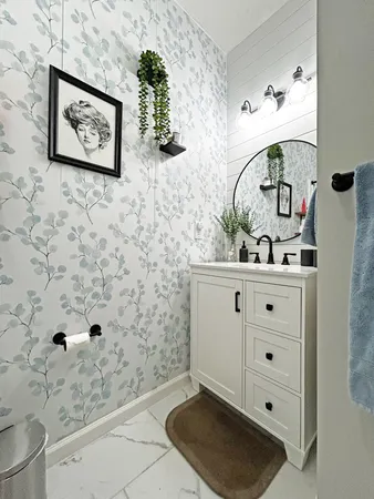 a bathroom with a sink a mirror and a shower